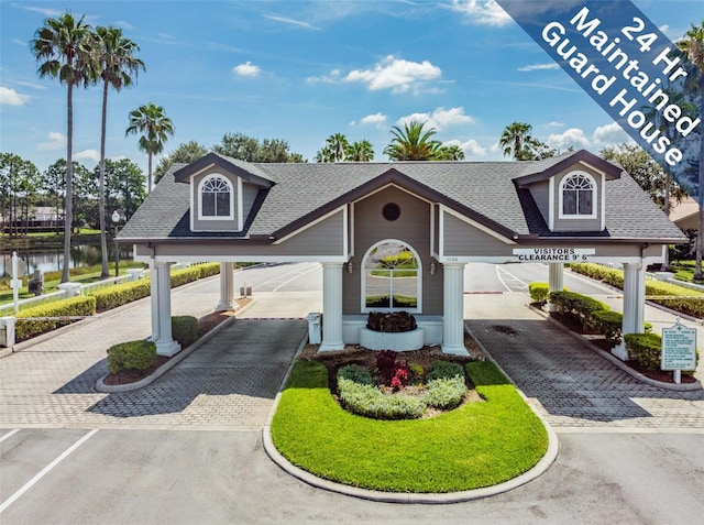 view of property's community featuring decorative driveway and a water view