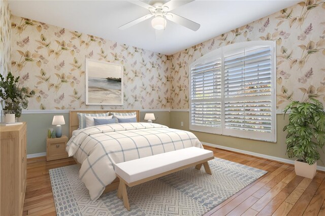 bedroom with baseboards, wallpapered walls, and light wood-style floors