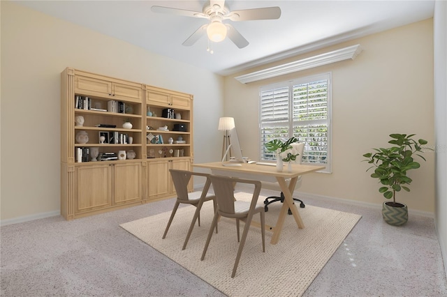 office space with baseboards and ceiling fan