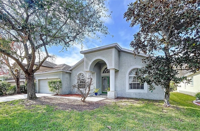 ranch-style home with a garage and a front lawn