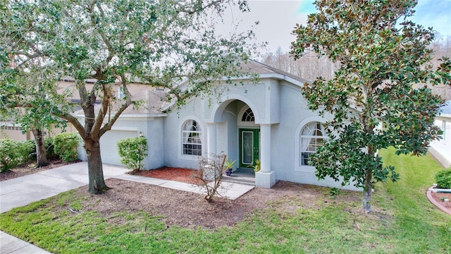 view of front facade featuring a garage and a front lawn