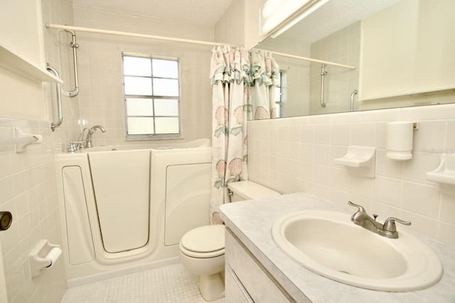 full bathroom with toilet, vanity, tile patterned flooring, tile walls, and shower / tub combo with curtain