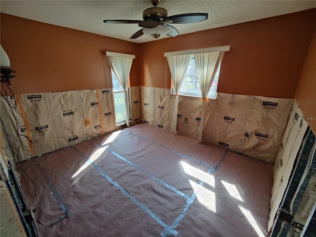 spare room featuring a textured ceiling and ceiling fan