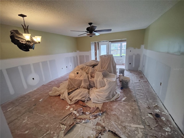 interior space with a notable chandelier and a textured ceiling