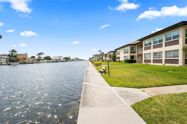 exterior space with a residential view, a water view, and a lawn