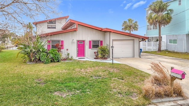 view of front of home with a garage and a front lawn