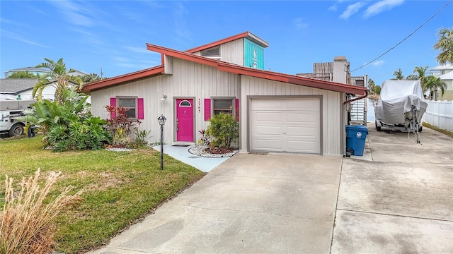 view of front of property with a garage and a front lawn