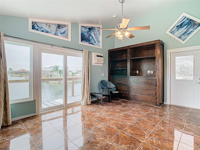 office space featuring a wall unit AC, vaulted ceiling, and ceiling fan