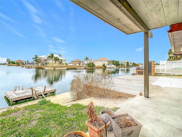 view of dock featuring a patio and a water view