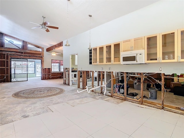 interior space featuring ceiling fan, decorative light fixtures, light tile patterned floors, and high vaulted ceiling