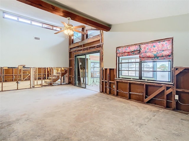 living room featuring ceiling fan, vaulted ceiling with beams, and concrete flooring