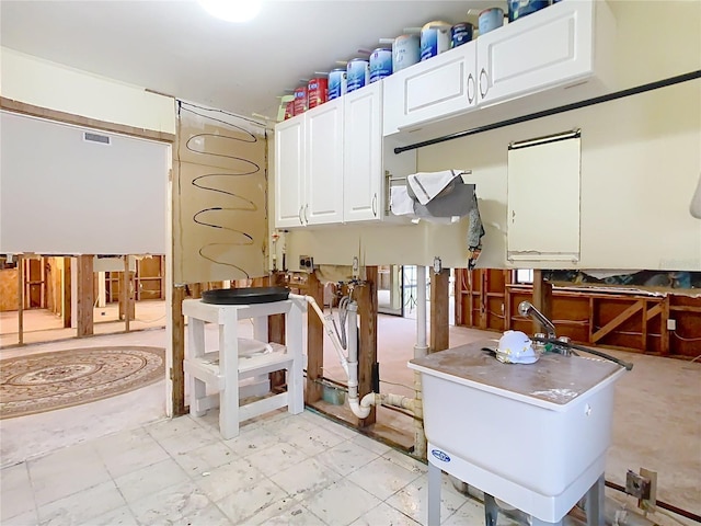 kitchen with sink and white cabinetry