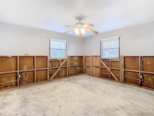 spare room featuring plenty of natural light and ceiling fan