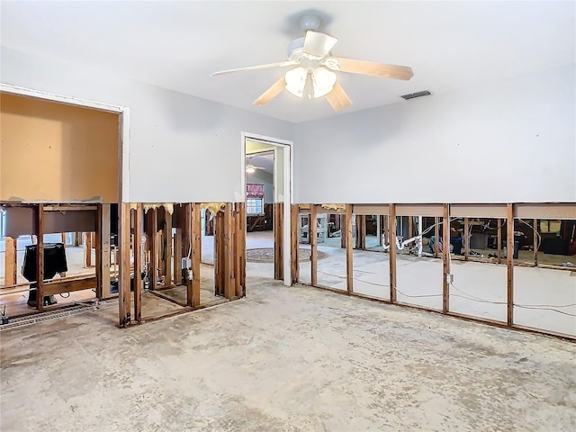 unfurnished room featuring ceiling fan and concrete floors