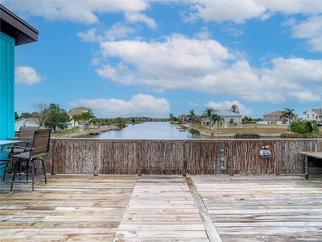 wooden terrace featuring a water view