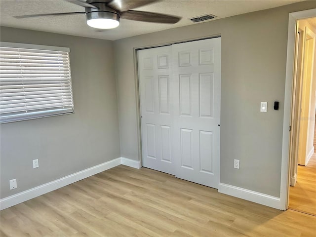 unfurnished bedroom featuring light wood finished floors, visible vents, and baseboards