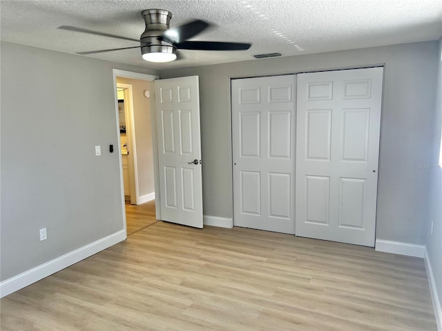 unfurnished bedroom with a closet, light wood-type flooring, and baseboards