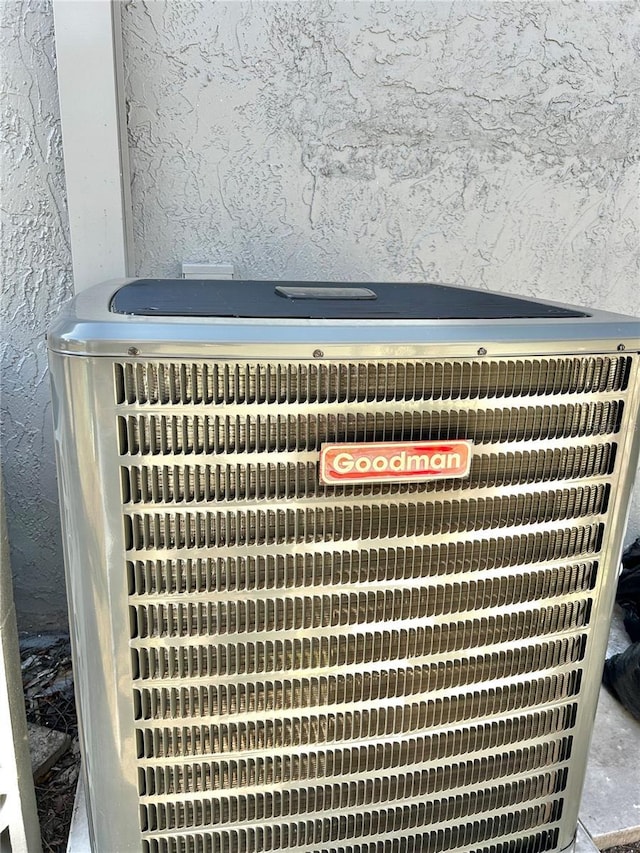 details with stucco siding and central AC unit