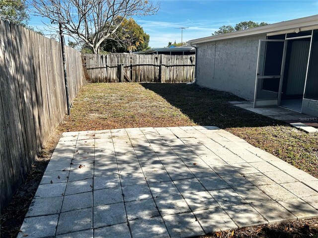 view of yard featuring a patio and a fenced backyard