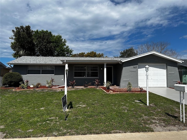 ranch-style house featuring concrete driveway, an attached garage, and a front lawn