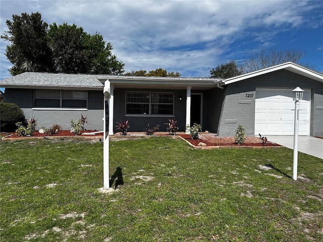 ranch-style home featuring a garage, driveway, a front lawn, and stucco siding