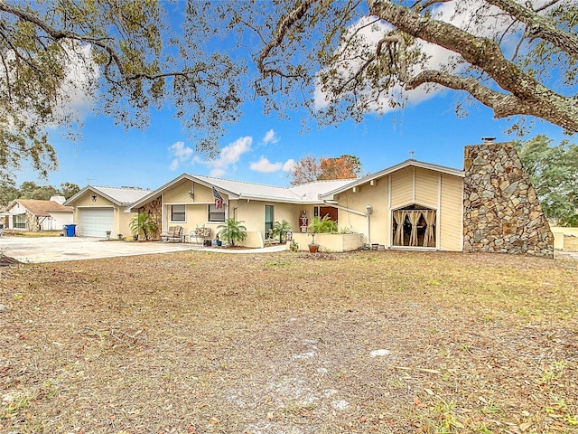 view of front of house with a garage and a front yard