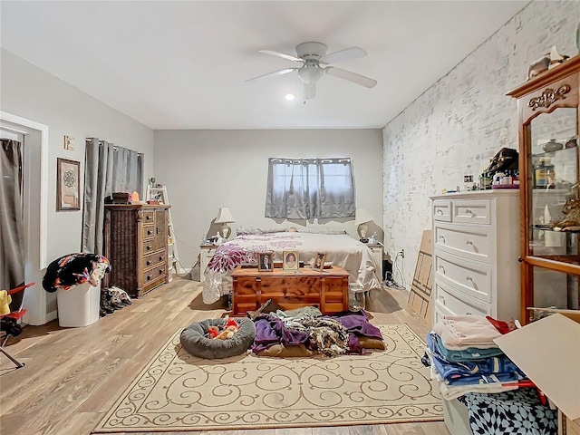 bedroom featuring light wood-type flooring and ceiling fan