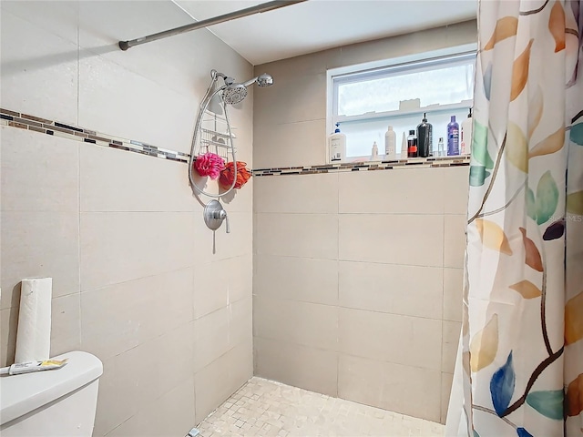 bathroom with toilet and curtained shower