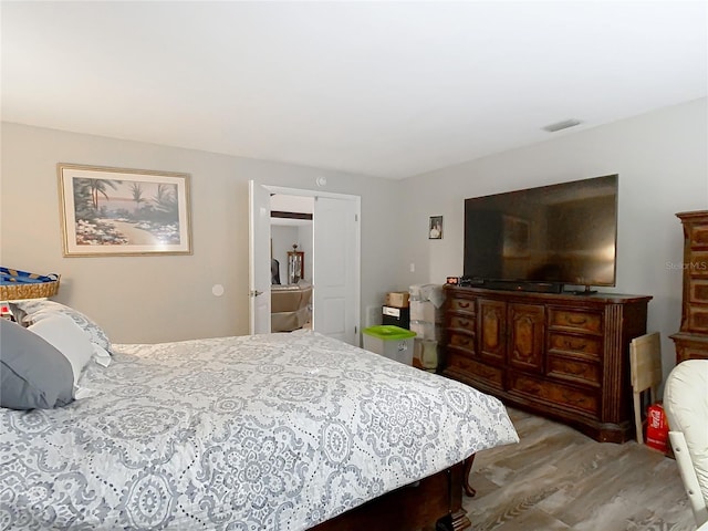 bedroom with hardwood / wood-style floors