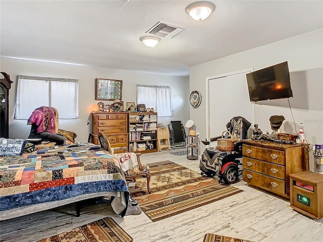 bedroom featuring hardwood / wood-style floors and multiple windows