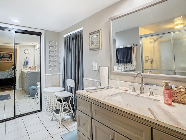 bathroom featuring toilet, tile patterned flooring, walk in shower, and vanity