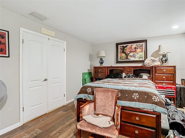 bedroom with a closet and hardwood / wood-style floors