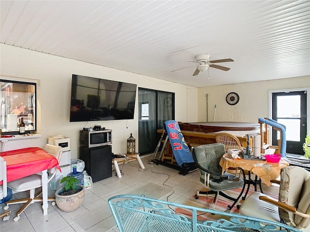 living room featuring ceiling fan and light tile patterned flooring