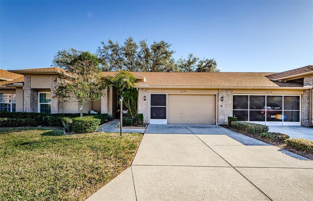 ranch-style house featuring a garage and a front lawn