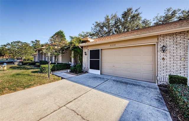 ranch-style house featuring a garage and a front lawn