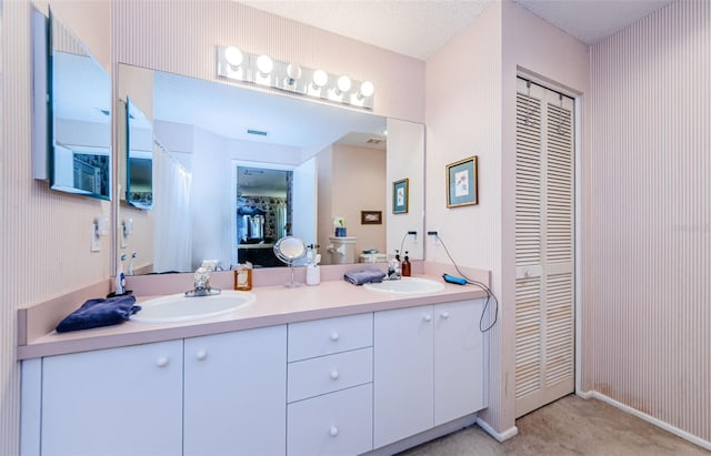 bathroom with vanity and a textured ceiling