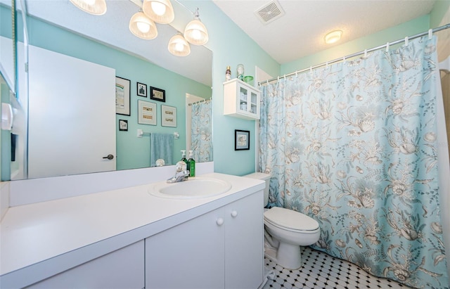 bathroom with vanity, a notable chandelier, a textured ceiling, and toilet