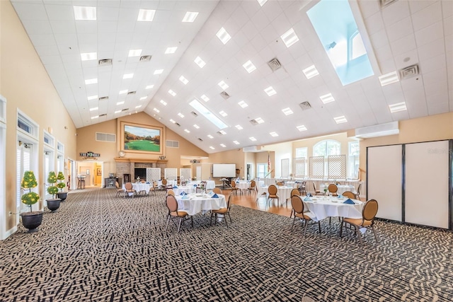 interior space with a high ceiling, carpet floors, and a wealth of natural light