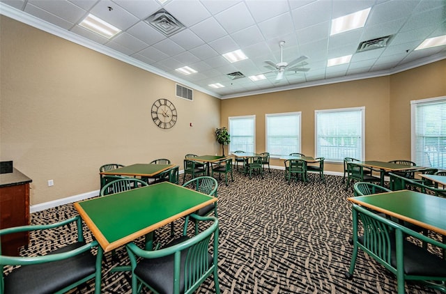 game room with crown molding, carpet flooring, a drop ceiling, and ceiling fan