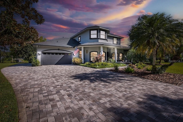 view of front of home featuring covered porch and a garage