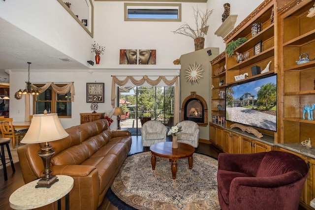 living room with hardwood / wood-style flooring and a notable chandelier