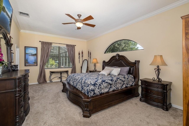 carpeted bedroom featuring ceiling fan and crown molding