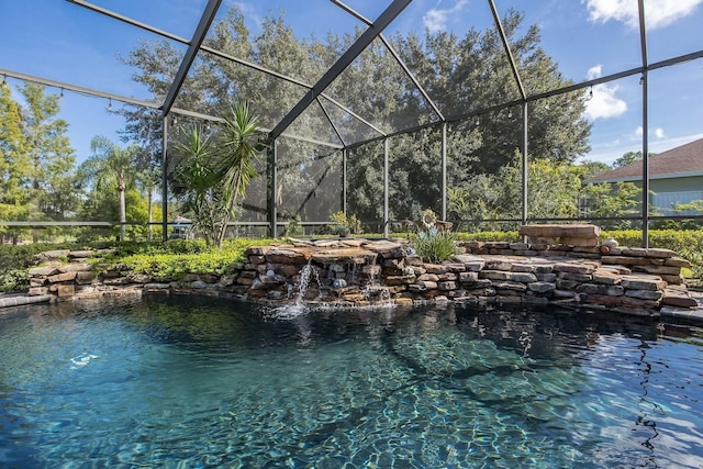 view of swimming pool with pool water feature and a lanai