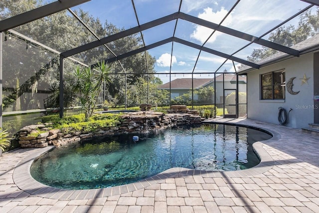 view of swimming pool with glass enclosure, a jacuzzi, and a patio