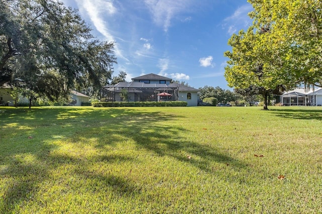 view of yard featuring glass enclosure