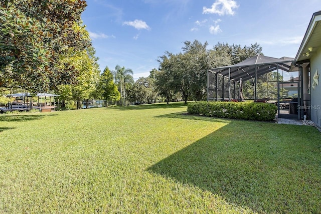 view of yard featuring glass enclosure