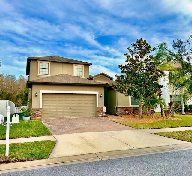 view of front facade with a garage and a front yard