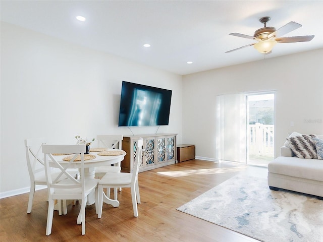 living room with hardwood / wood-style flooring and ceiling fan