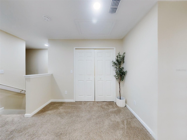 unfurnished bedroom featuring carpet and a closet