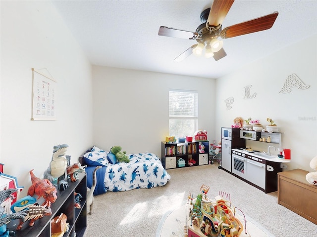 recreation room featuring ceiling fan and carpet floors